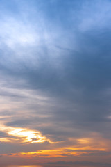 sunset / sun rise sky with rays of yellow and red light shining clouds and sky background and texture