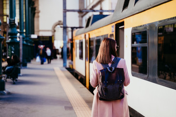 happy young woman walking at train station. Travel concept - obrazy, fototapety, plakaty