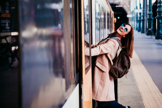 Happy Young Woman At Train Station. Travel Concept