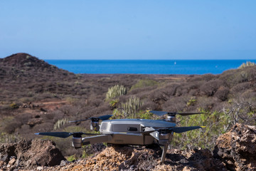 Close up of a drone with the sea on the horizon. Stunning blue sea view. Tropical landscape. Game or work activities.