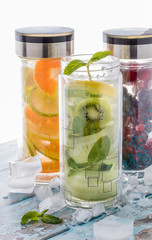 Front view close up of three bottles filled with fruit infused flavoured water.