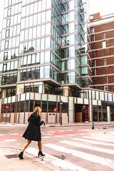 Woman with a coffee walking in the city