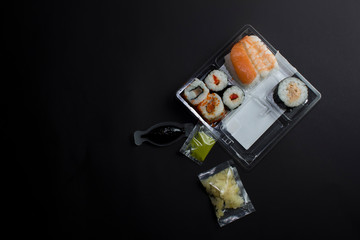 Sushi box kiku. Top view on black background