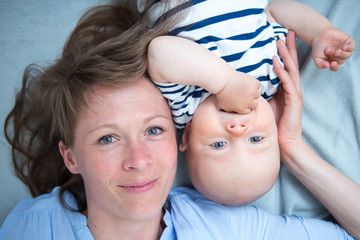 Cute baby with mother at home