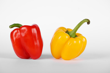 Red and yellow color peppers on white background