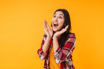 Photo of delighted cute woman expressing surprise and looking upward