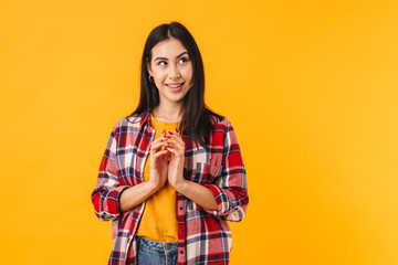 Photo of pleased brunette woman smiling while looking aside