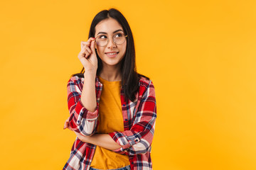Photo of pleased brunette woman smiling while looking aside