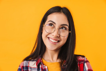 Photo of pleased brunette woman smiling while looking upward