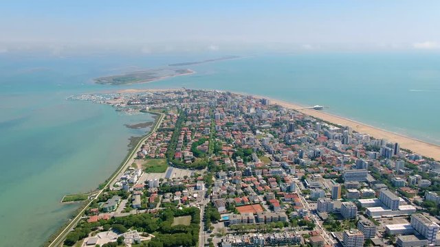 Aerial of Lignano Sabbiadoro town located among Marano Lagoon and Adriatic sea, Italy