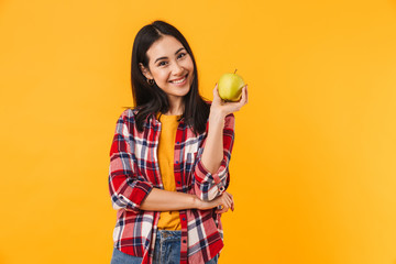 Photo of happy young woman smiling and holding apple