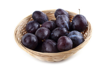 Black plums on wicked plate