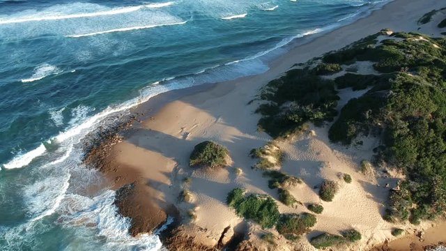 Aerial of Sandy Shore in Tofo Mozambique with Crashing Waves