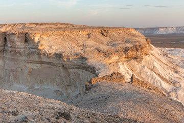 Sunrise over Ustyurt Plateau. District of Boszhir. The bottom of a dry ocean Tethys. Rocky remnants. Kazakhstan. selective focus