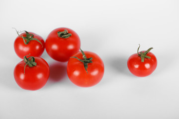 Random selected tomatoes on white background with shadows. Top view