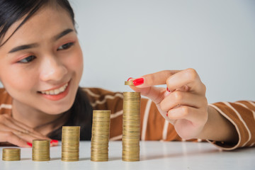 Young beautiful woman with stack of coins, invest growing increase profit concept.