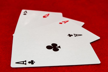 Four aces on a red background