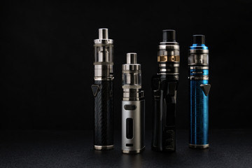 electronic cigarettes or vaping devices on black background