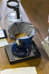 Alternative manual coffee brewing. Pour over dripper with paper filter on Scales