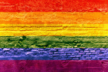 Gay flag painted on a brick wall, Rainbow background
