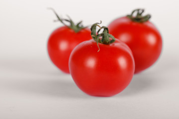 Three fresh tomatoes on white background