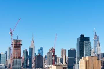 Fototapeta na wymiar Midtown Manhattan Skyline seen from Long Island City New York with Construction and a Blue Sky
