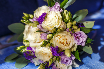 bright wedding bouquet of summer white violet roses  with wedding rings