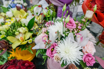 Fototapeta na wymiar Beautiful bouquet of mixed flowers. Floral shop, flower market. Selective focus.