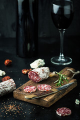 Salami with spices, rosemary and a glass of wine