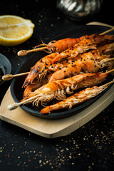 Delicious grilled shrimp with lemon, spices and sauce