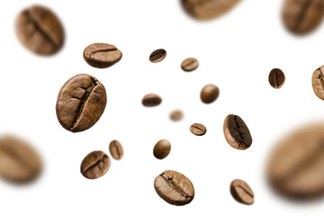 Brown roasted coffee beans falling and flying on black background.Represent breakfast for energy and freshness concept.