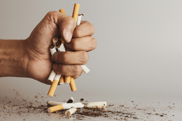 Hand clutching cigarette and crush for destroy.Cigarettes is addictive to be cancer.smoking...