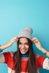 Image of happy beautiful woman smiling and making fun with knit cap