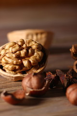 hazelnut in a shell close-up on a textured wooden background
