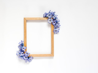 Wood frame and creative composition of spring blue flowers hyacinth on white background. Top view. Copy space, flat lay, International Women Day. greeting card, place for an inscription, 8 march