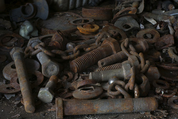 Old and rusty screws in a car workshop