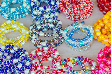 The colorful stone is used to make beautiful bracelets. Is a religious belief of Thai people that will have good luck for sale on the local market in Kanchanaburi, Thailand. Selective focus.
