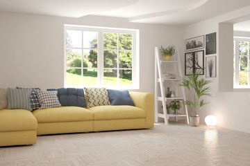Fototapeta premium Minimalist living room in white color with sofa and summer landscape in window. Scandinavian interior design. 3D illustration