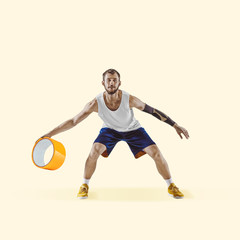 Fototapeta na wymiar Basketball player with big duct tape on yellow background. Copyspace for your proposal. Modern design. Contemporary artwork, collage. Concept of sport, office, hard work, dreams, business, action.