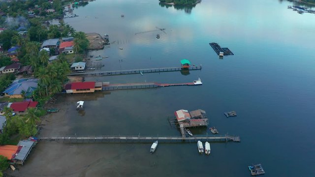 Aerial footage of Beautiful Rural village landscape with green forest in surrounding in Mengkabong River, Tuaran, Sabah, Borneo