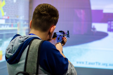 Guy shooting in virtual shooting gallery