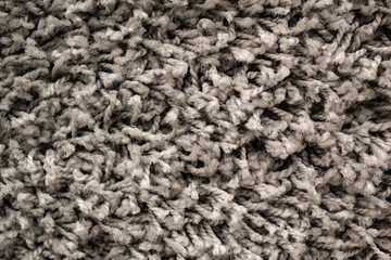 Texture of grey long-pile carpet. Abstract background of a shaggy texture with long fibers