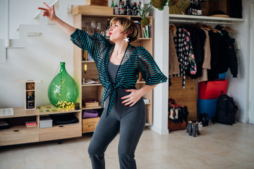 adult woman indoor listening music dancing