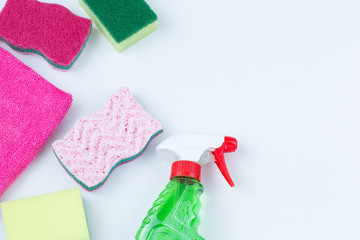 glass cleaner, rag and various sponges on a white background