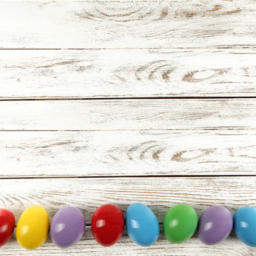 Easter eggs on white wooden desk and free space for your decoration. 