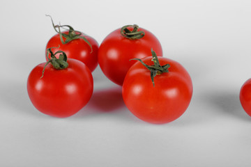 Random selected tomatoes on white background