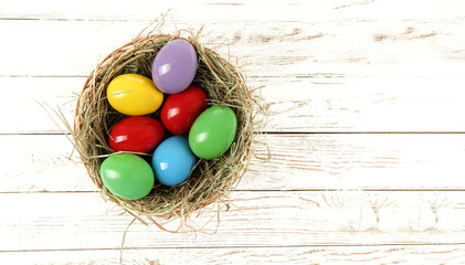 Easter eggs on white wooden desk and free space for your decoration. 