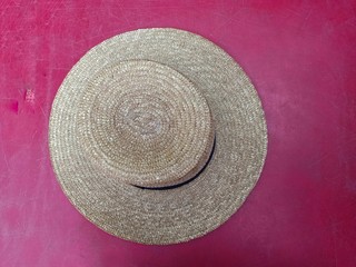 Fototapeta na wymiar Straw hats placed on red backgrounds.