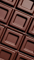 Dark chocolate pieces isolated on white background. Top view.
