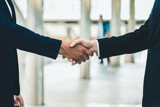 Two businessman shake hand for the first meeting. Two business people greeting outdoor.